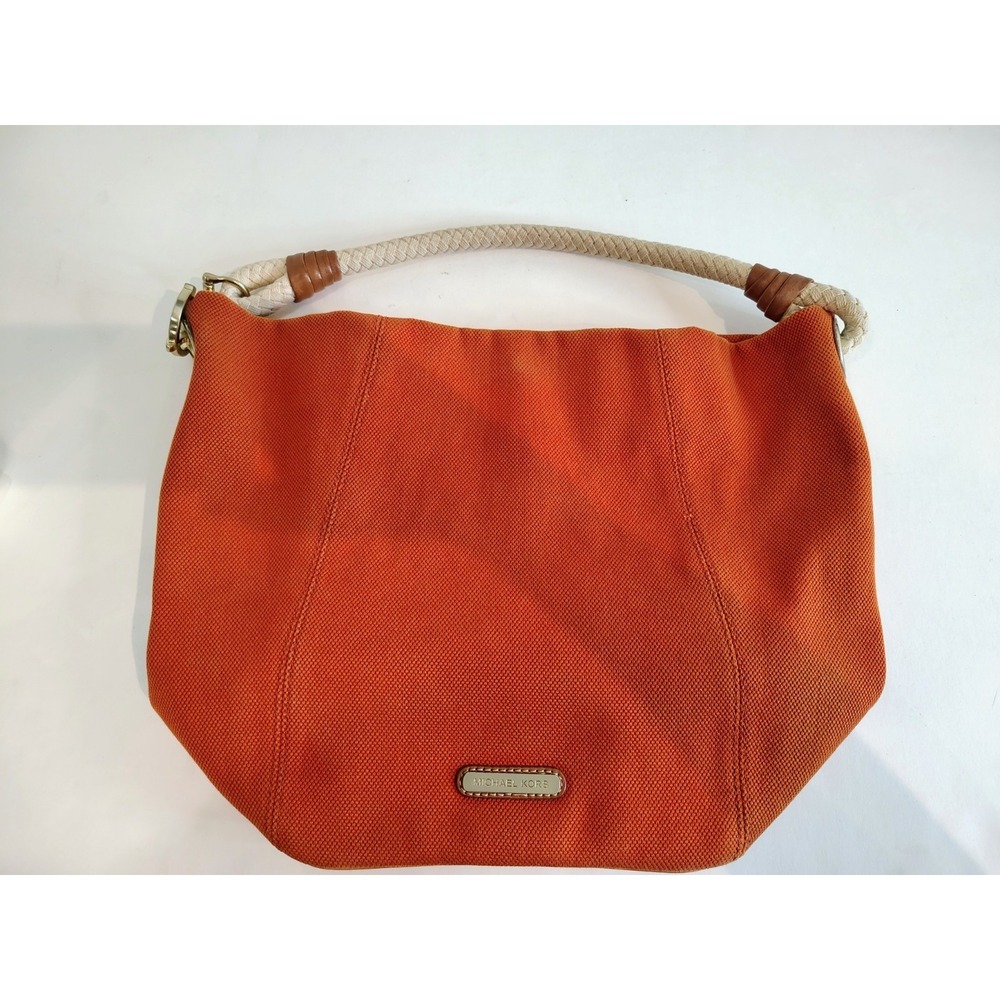 Michael Kors Marina hobo bag features an orange canvas body with braided rope...